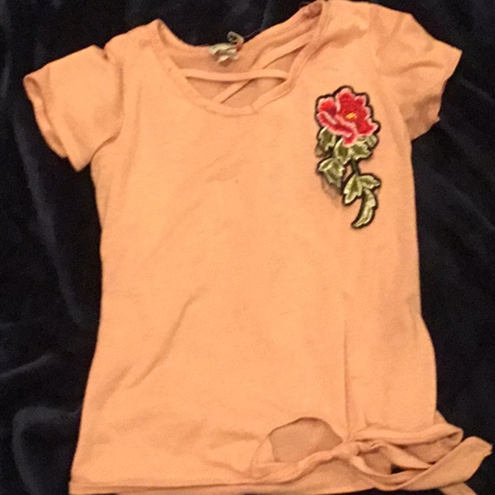 A pink T-shirt with a rose